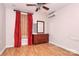 Cozy bedroom with hardwood floors, red accents, and a bright, natural light at 729 Lochaven Rd, Waxhaw, NC 28173