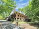 Charming two-story home featuring a spacious porch, stone chimney, and lush landscaping at 729 Lochaven Rd, Waxhaw, NC 28173