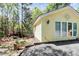 Charming yellow home with lush greenery, stone accents and detailed compass rose fixture at 729 Lochaven Rd, Waxhaw, NC 28173