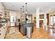 Bright kitchen featuring stainless steel appliances, custom cabinets, and center island at 729 Lochaven Rd, Waxhaw, NC 28173