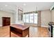 Open living space with hardwood floors, custom kitchen details, and a large window at 729 Lochaven Rd, Waxhaw, NC 28173