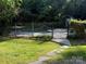 Fenced in pool area, landscaped with grassy area and stone walkway at 729 Lochaven Rd, Waxhaw, NC 28173