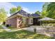 Well-maintained backyard with brick accents, patio furniture, and lush landscaping, ideal for outdoor entertaining at 7815 Scottsburg Ct, Mint Hill, NC 28227