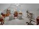 Spacious bonus room with sloped ceilings and ample furniture, perfect for a home office or entertainment area at 7815 Scottsburg Ct, Mint Hill, NC 28227