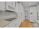 Updated kitchen with white cabinetry, stainless appliances, and hardwood flooring at 7815 Scottsburg Ct, Mint Hill, NC 28227