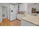 Bright kitchen features white cabinets, wooden floors, modern appliances, and a cozy area rug at 7815 Scottsburg Ct, Mint Hill, NC 28227