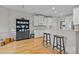 Bright kitchen featuring hardwood floors, white cabinetry, and a breakfast bar at 7815 Scottsburg Ct, Mint Hill, NC 28227
