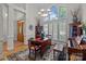 Elegant living room with large windows, hardwood floors, and a decorative rug at 7815 Scottsburg Ct, Mint Hill, NC 28227