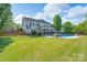 An expansive backyard featuring a sparkling pool, patio area, and lush green grass at 8014 Avanti Dr, Marvin, NC 28173