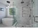 This bathroom features a glass shower with a rain shower head and a luxurious soaking tub at 8014 Avanti Dr, Marvin, NC 28173