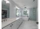 An elegant bathroom featuring dual sinks, a soaking tub, walk-in shower, and a spacious walk-in closet at 8014 Avanti Dr, Marvin, NC 28173