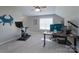 This flex room features an open layout, ceiling fan, and multiple monitors for working from home at 8014 Avanti Dr, Marvin, NC 28173