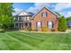 Beautiful two-story brick home with a well-manicured lawn and inviting front porch at 8014 Avanti Dr, Marvin, NC 28173