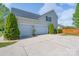 Spacious three-car garage with plenty of parking and curb appeal surrounded by manicured landscaping at 8014 Avanti Dr, Marvin, NC 28173