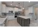 Well-equipped kitchen with granite countertops, stainless steel appliances, and center island at 8014 Avanti Dr, Marvin, NC 28173