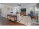 Comfortable living room showcasing hardwood floors, fireplace, and large windows for natural light at 8014 Avanti Dr, Marvin, NC 28173