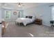 Serene main bedroom with tray ceiling, neutral tones, plush carpeting, and ample natural light at 8014 Avanti Dr, Marvin, NC 28173