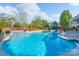 Gorgeous pool with lounge chairs and lush landscaping in a private backyard oasis at 8014 Avanti Dr, Marvin, NC 28173