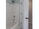 Shower-tub combo with chrome shower head inside a door to a brightly-lit bathroom at 8014 Avanti Dr, Marvin, NC 28173