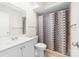 Bathroom showcasing a vanity sink, toilet, and shower with patterned curtain, offering essential amenities at 817 Sardis Cove Dr, Charlotte, NC 28270