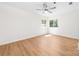 Large bedroom with wood-look flooring, a ceiling fan, and natural light from a window at 817 Sardis Cove Dr, Charlotte, NC 28270