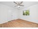 Bright bedroom with wood-look flooring, a ceiling fan, and a window providing natural light at 817 Sardis Cove Dr, Charlotte, NC 28270