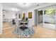 Cozy dining area with a modern round table, stylish chairs, and a sliding glass door to the outside at 817 Sardis Cove Dr, Charlotte, NC 28270