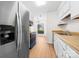 Bright kitchen featuring stainless steel appliances, white cabinets, and modern fixtures at 817 Sardis Cove Dr, Charlotte, NC 28270