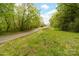 Nature path surrounded by mature trees and grassy areas, perfect for outdoor strolls at 817 Sardis Cove Dr, Charlotte, NC 28270