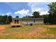 View of back exterior with sliding glass door leading to wooden deck at 828 Long Bow Rd, Salisbury, NC 28144
