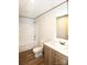 A bathroom featuring a combined tub and shower, wood-look flooring, and white marble countertops at 828 Long Bow Rd, Salisbury, NC 28144