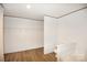 View of bathroom featuring toilet, tub, walk-in closet and wooden flooring at 828 Long Bow Rd, Salisbury, NC 28144