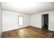 Bedroom featuring wood-look flooring, a window for natural light, and an entrance to the bathroom at 828 Long Bow Rd, Salisbury, NC 28144