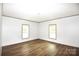Spacious bedroom featuring two windows for natural light and wood-look flooring throughout at 828 Long Bow Rd, Salisbury, NC 28144