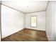 This is a spacious bedroom featuring wood flooring and a window for ample natural light at 828 Long Bow Rd, Salisbury, NC 28144
