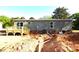 Back of the home featuring a small deck, gray siding, and access to utilities at 828 Long Bow Rd, Salisbury, NC 28144