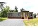 Charming single-story home features a covered porch, gravel driveway and tidy landscaping at 828 Long Bow Rd, Salisbury, NC 28144