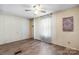 Neutral bedroom with wood-look floors, ceiling fan and plenty of natural light at 8705 Carroll St, Hickory, NC 28601