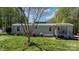 Charming home featuring manicured lawn and landscaping and covered entry at 8705 Carroll St, Hickory, NC 28601