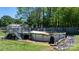 Backyard features an above ground pool with deck and landscaping with rock border at 8705 Carroll St, Hickory, NC 28601