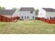 View of the spacious backyard featuring a wooden fence and a small patio at 8820 First Run Ct, Charlotte, NC 28215