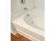 Bathroom featuring a clean, white bathtub with jets and wood-look flooring at 8820 First Run Ct, Charlotte, NC 28215