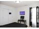 Bedroom featuring a wall-mounted TV, desk, and black-out curtains at 8820 First Run Ct, Charlotte, NC 28215