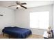Bright bedroom featuring a ceiling fan, a large window with blinds, and neutral carpet at 8820 First Run Ct, Charlotte, NC 28215