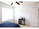 Clean bedroom with a ceiling fan, window with blinds, and a small table with accessories at 8820 First Run Ct, Charlotte, NC 28215