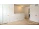 Upstairs bedroom with closet space, door to additional rooms and neutral walls at 8820 First Run Ct, Charlotte, NC 28215