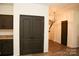 Entryway featuring hardwood floors with stairs along the wall, leading into a living space at 8820 First Run Ct, Charlotte, NC 28215