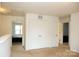 Bright hallway with neutral carpeting, leading to bedrooms with closet and bathroom entrances at 8820 First Run Ct, Charlotte, NC 28215