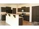 Modern kitchen with granite countertops, sleek black cabinets, and stainless steel appliances at 8820 First Run Ct, Charlotte, NC 28215