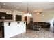 Open concept living space featuring wood-look floors, a cozy sectional, and a kitchen bar at 8820 First Run Ct, Charlotte, NC 28215